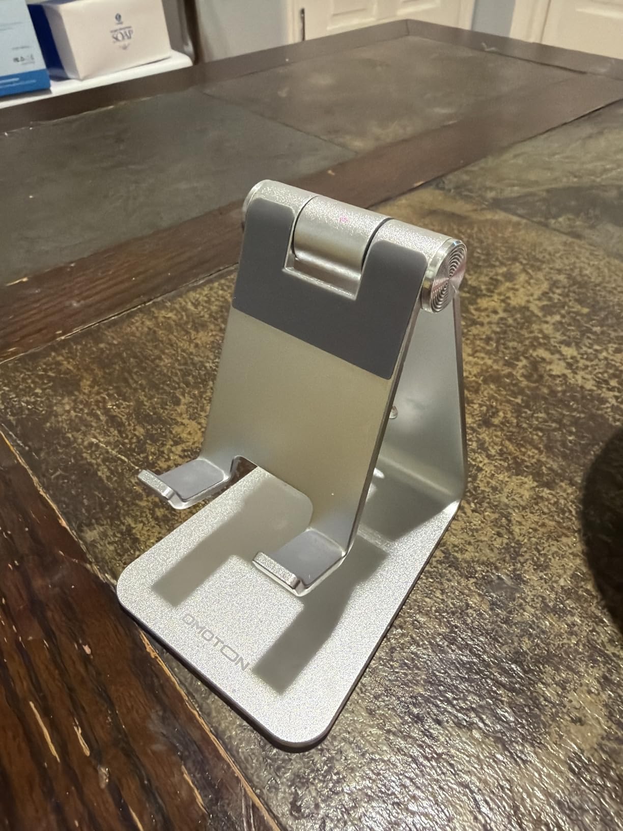 Adjustable Cell Phone Stand, OMOTON Aluminum Desktop Cellphone Stand with Anti-Slip Base and Convenient Charging Port, Fits All Smart Phones, Silver - Customer Photo 2