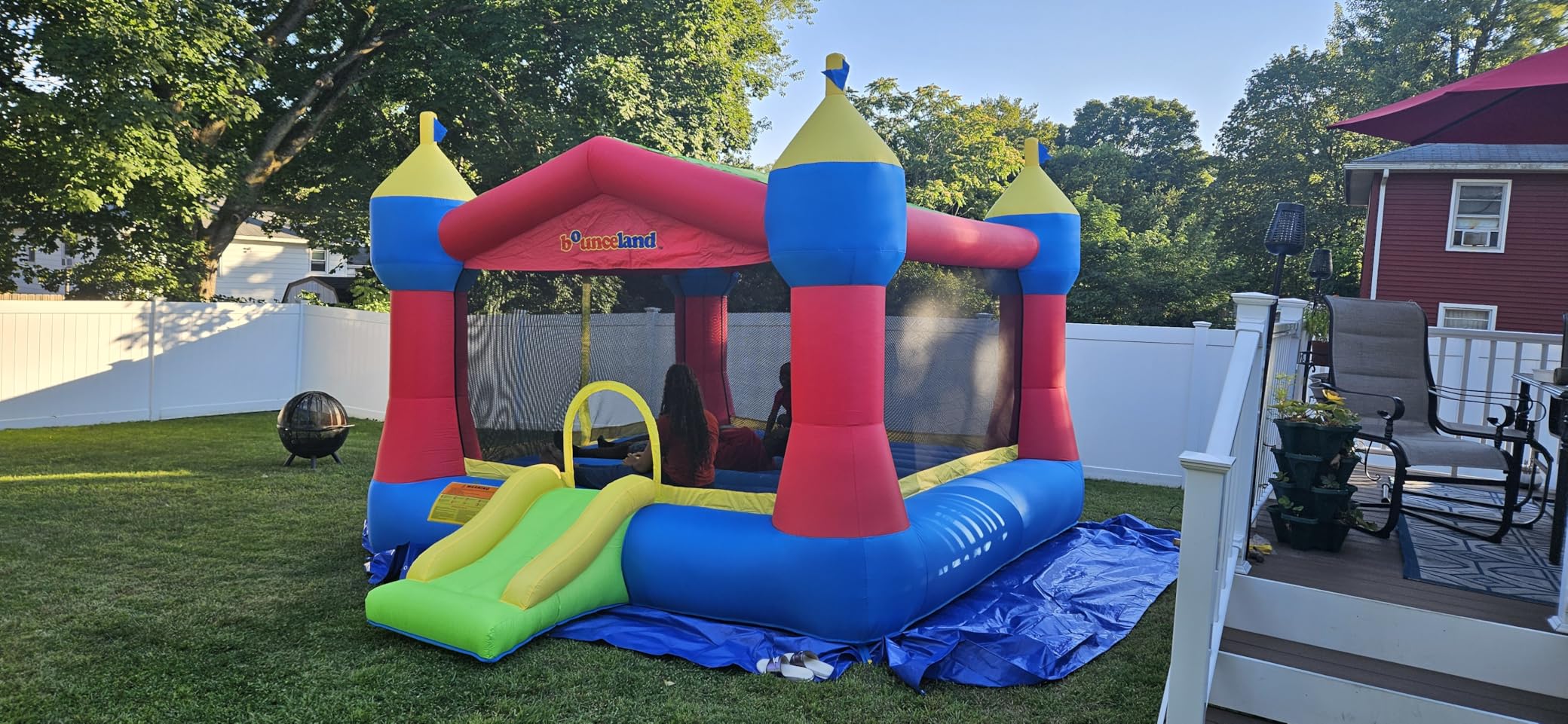 Bounceland Inflatable Party Castle Bounce House Bouncer, 16 ft L x 13 ft W x 10.3 ft H, Basketball Hoop, Removable Sun Roof, UL Strong Blower included, Fun Slide and Bounce Area, Castle Theme for Kids customer photo 2