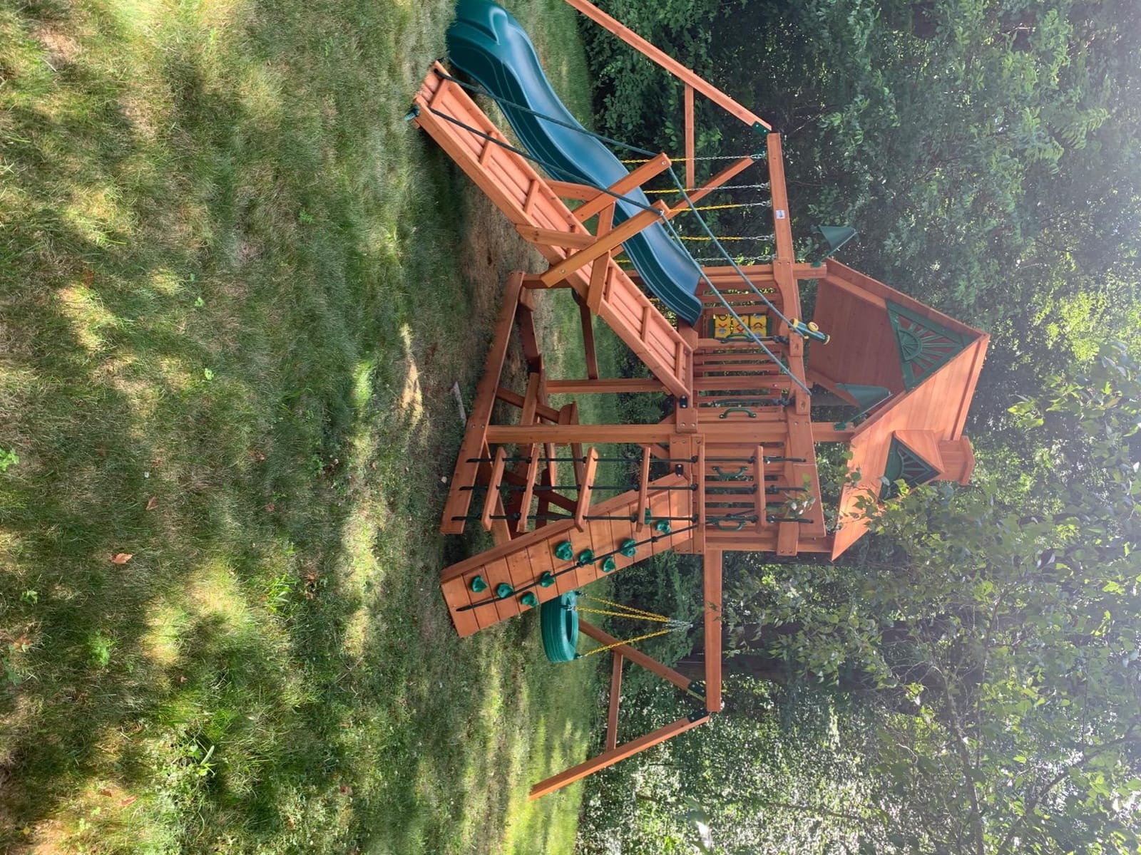 Gorilla Playsets 01-0004-AP Frontier Wood Swing Set with Wood Roof, Tire Swing, Two Belt Swings, Picnic Table, Sandbox, Rock Climbing Wall, Amber customer photo 1